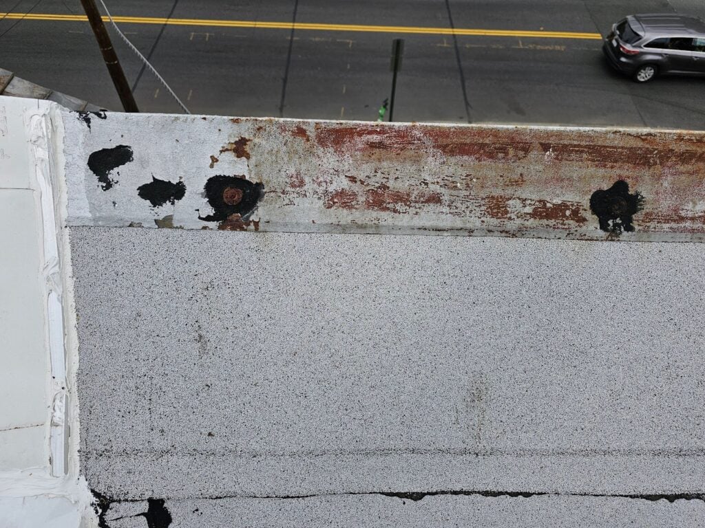 Loose cap nails creating leak risk at DC rooftop