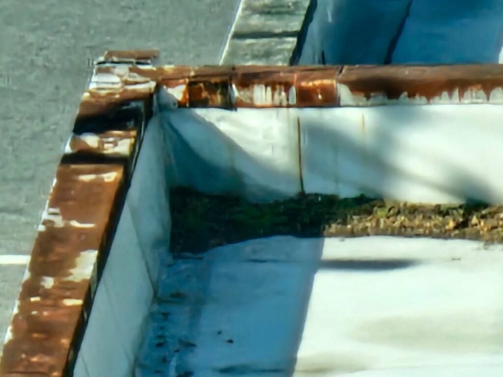 Debris buildup causing roof drain clog in DC structure
