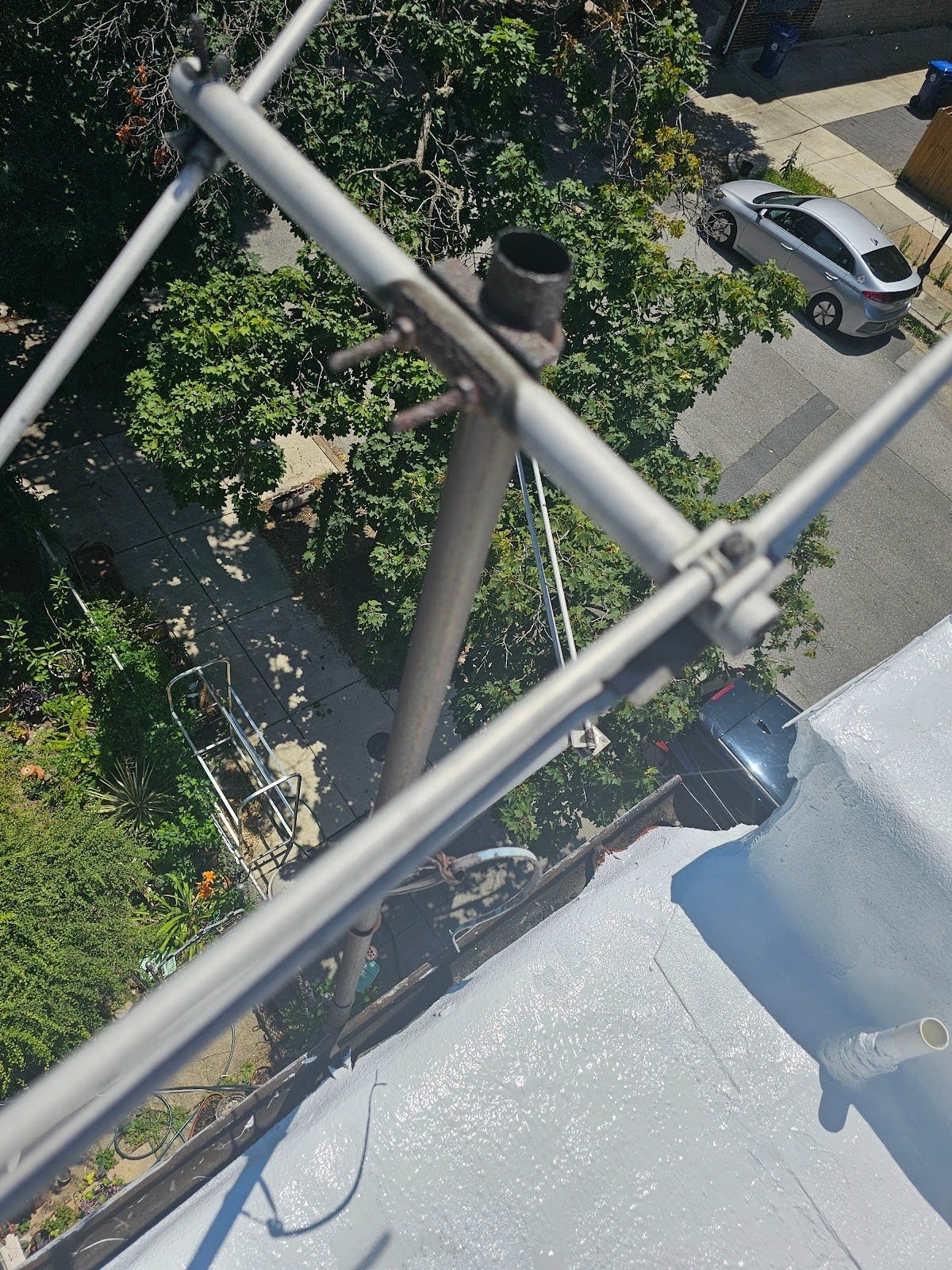 Damaged antenna and satellite dishes on rooftop structures