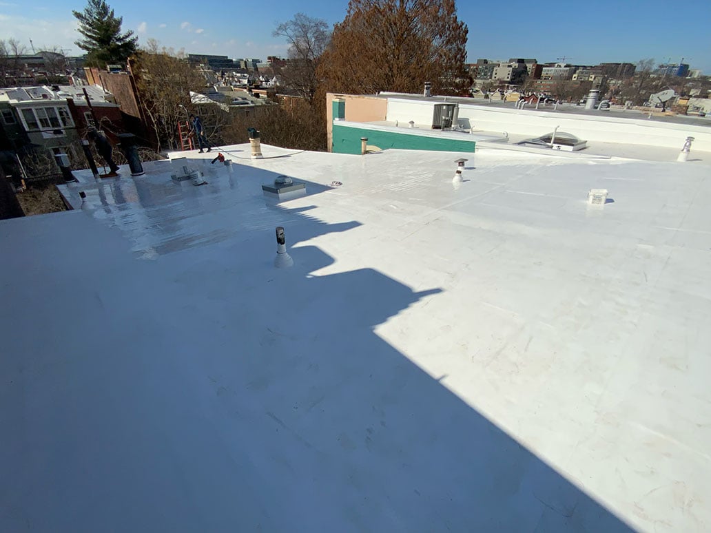 Dupont Circle DC roofers installing new asphalt shingles on rowhouse