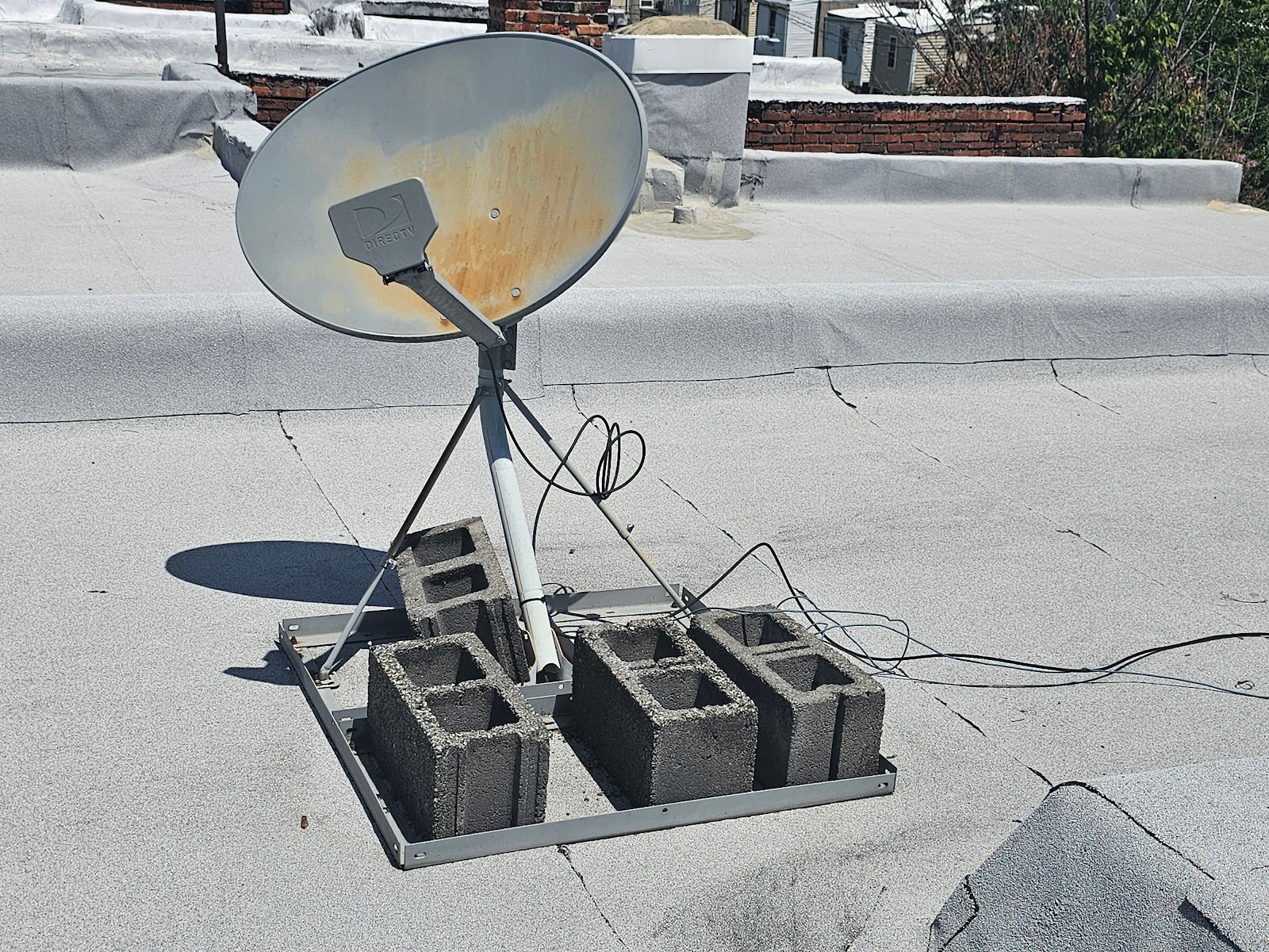 Technician adjusting antenna and satellite dish on roof – Washington DC