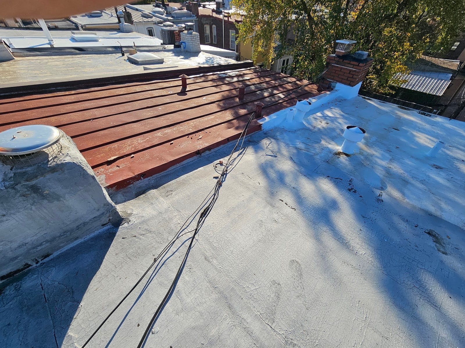 Cabling dangled across old rooftop buildings
