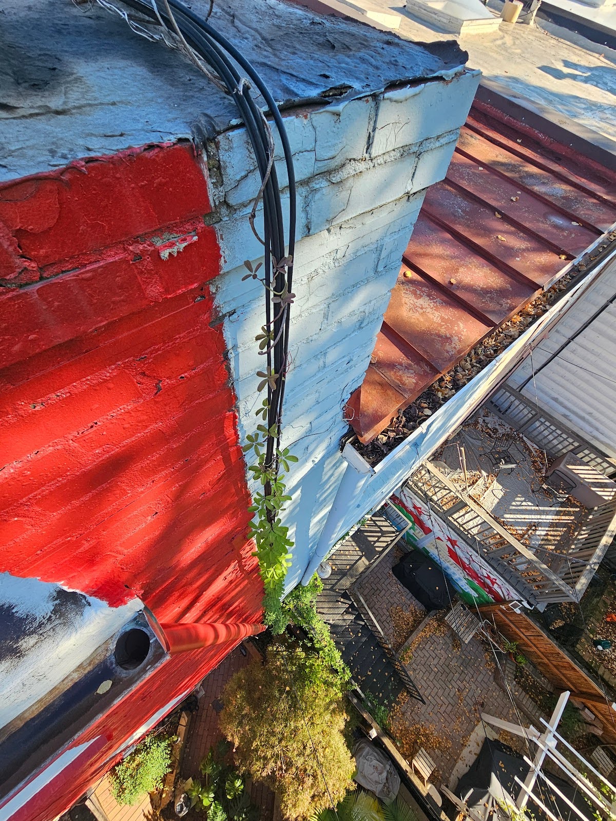 Electrical cabling dangled loosely above street houses