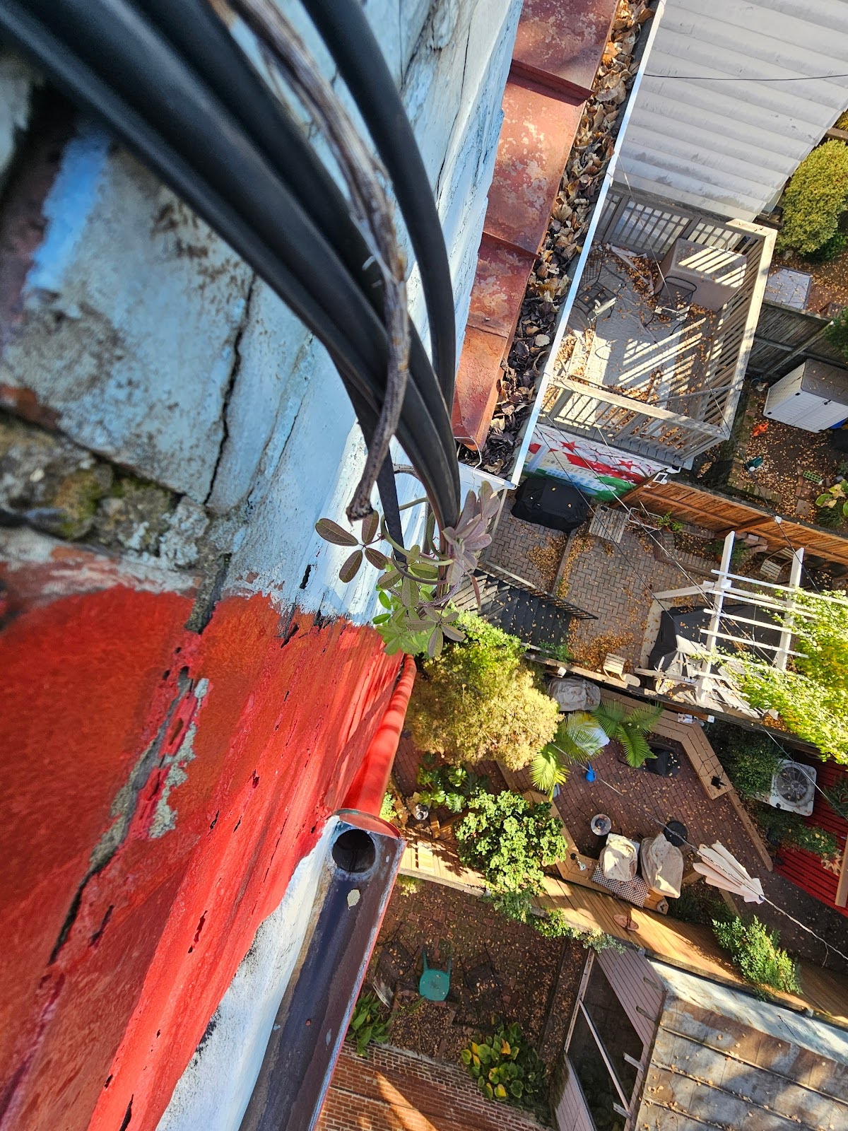 Network cabling dangled from rooftop poles in urban area