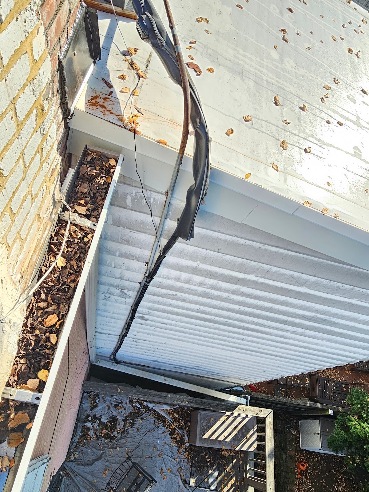 Overhead cabling dangled between rooftops and walls