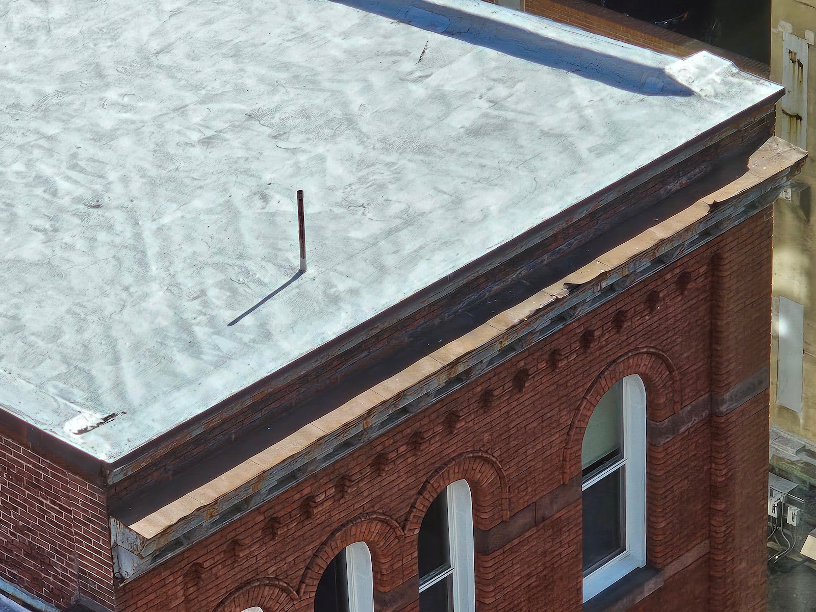 Close-up view of water table flashing above cornice