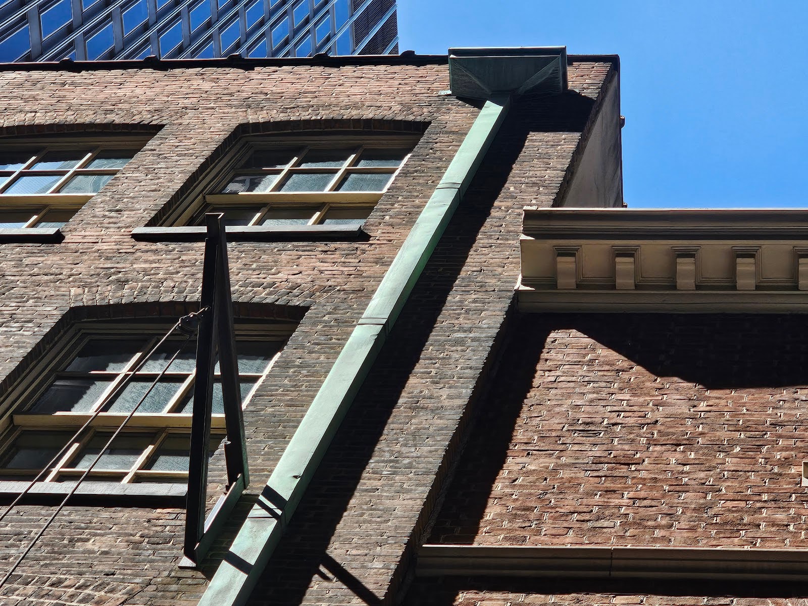 Corroded metal gutter contributing to leaks on a heritage building