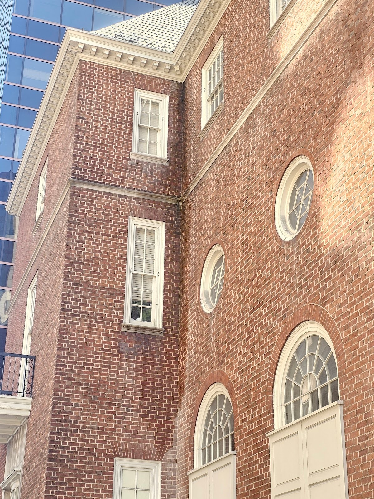Leaking gutter causing water damage on a historic building facade