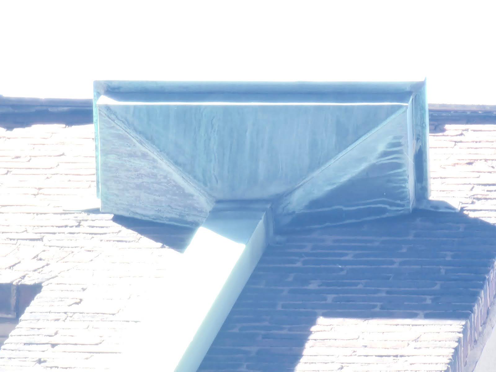 Water stains below a leaking gutter on a historic architectural wall