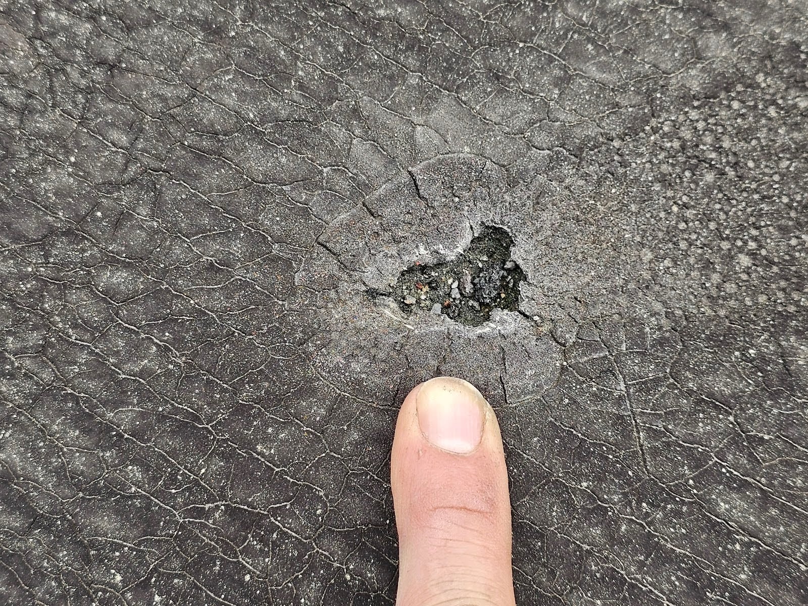 Exterior roof damage caused by improperly disposed trash next door