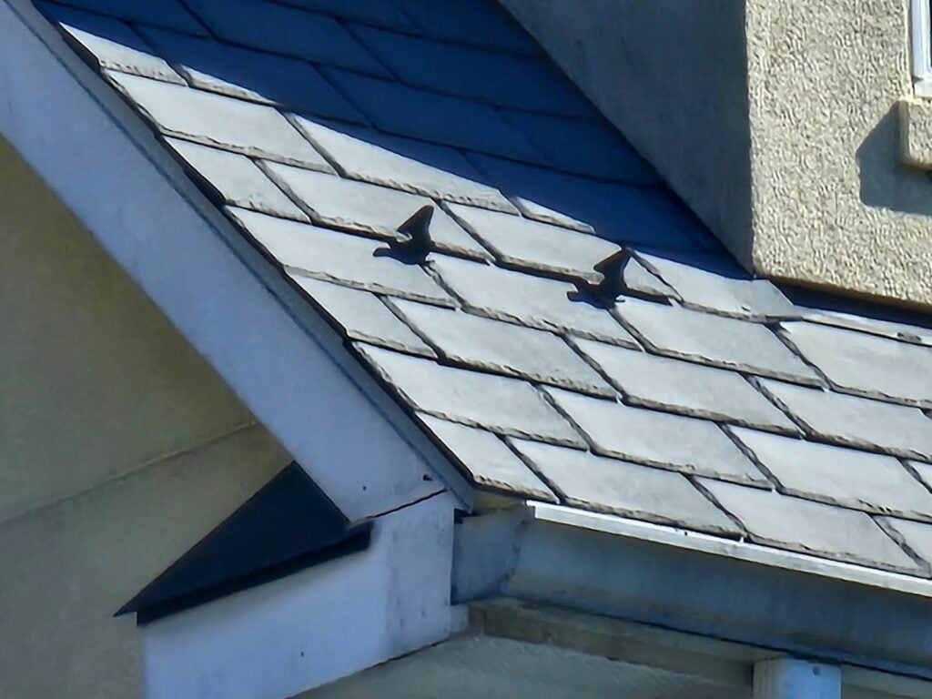 Exterior view of gable roof with multiple dormer structures