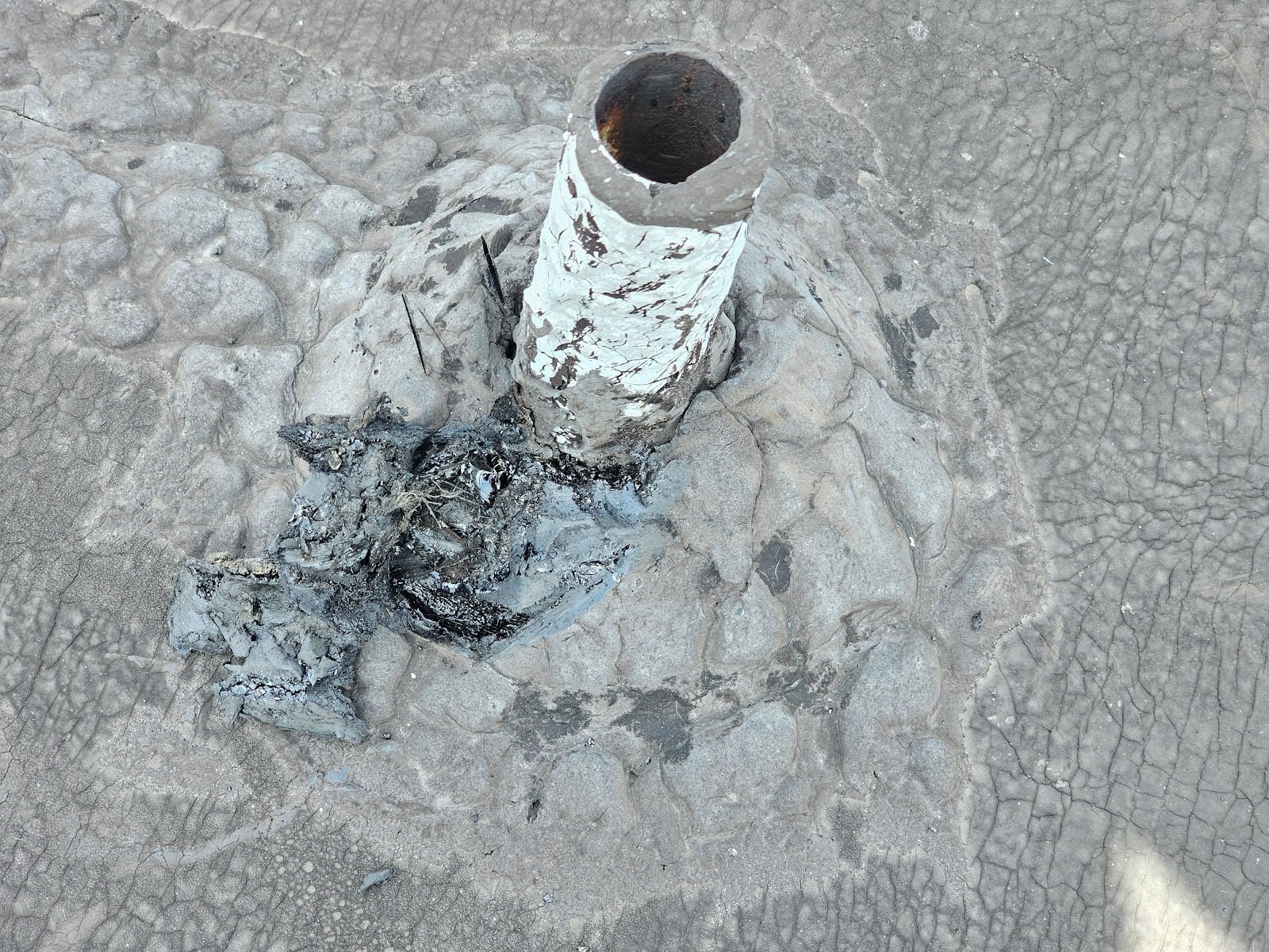 Leaking Flat Roof Penetration - Part I 2 hot scraping knife and removed a part of the piled on tar