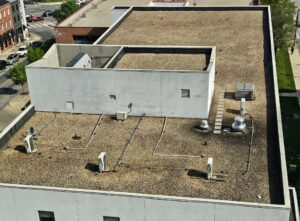 Home 13 Ballasted flat roof covered with stone aggregate on commercial building