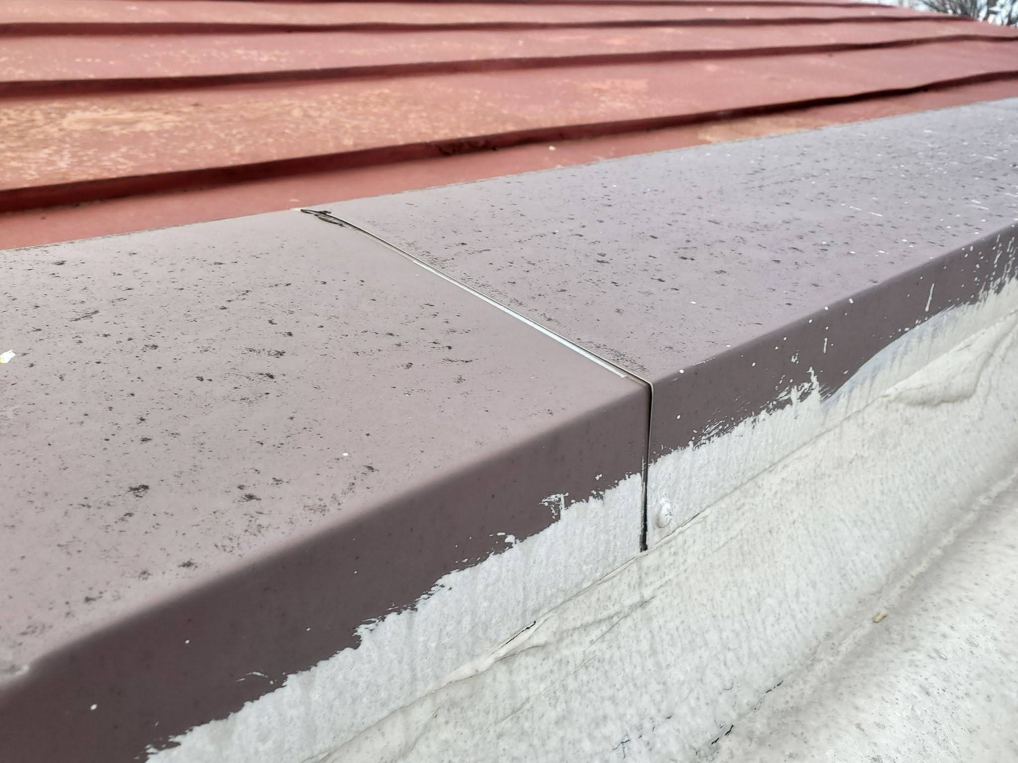 Close-up of parapet wall coping designed to protect masonry from water intrusion