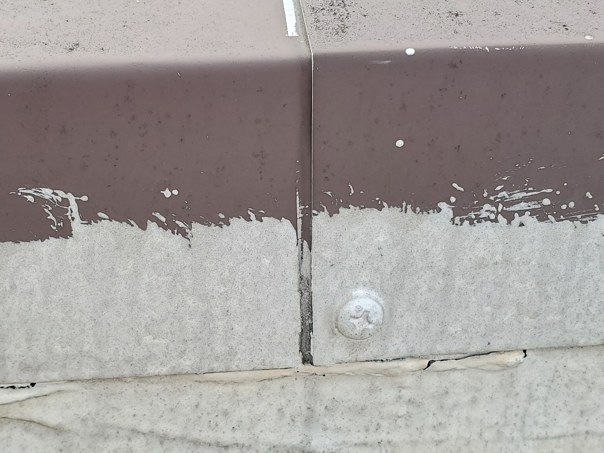 Parapet coping maintenance and repair work on flat roof perimeter wall