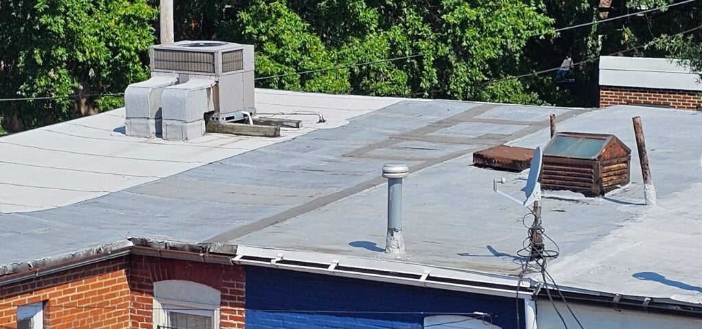 Close-up of a roof with a continuous parapet between adjoining structures