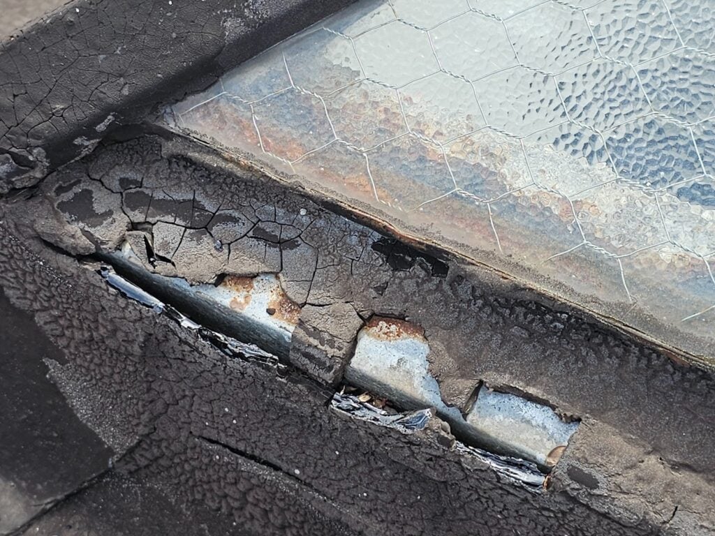 Roof repair work around a leaking skylight