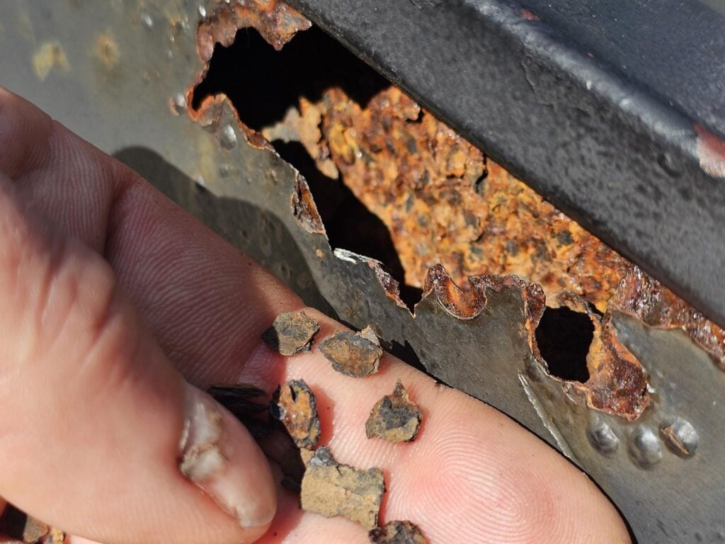 Close-up of extreme ferrous metal oxidation crumbling into disintegrated particles on a Washington DC historic roof