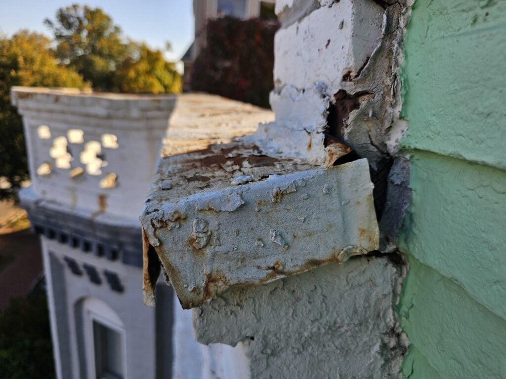 Ferrous metal coping pulled away from masonry wall leaving an open gap with no counter flashing installed, Washington DC